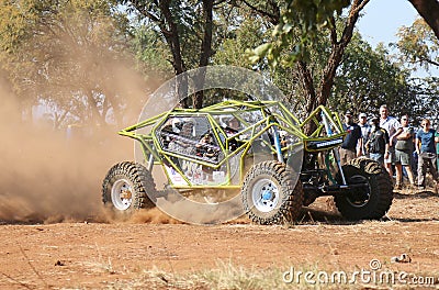 Neon green car kicking up dust during speed timed trial event Editorial Stock Photo